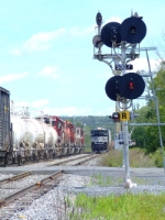 The engineer of 412 sticks his hand out the window for 169